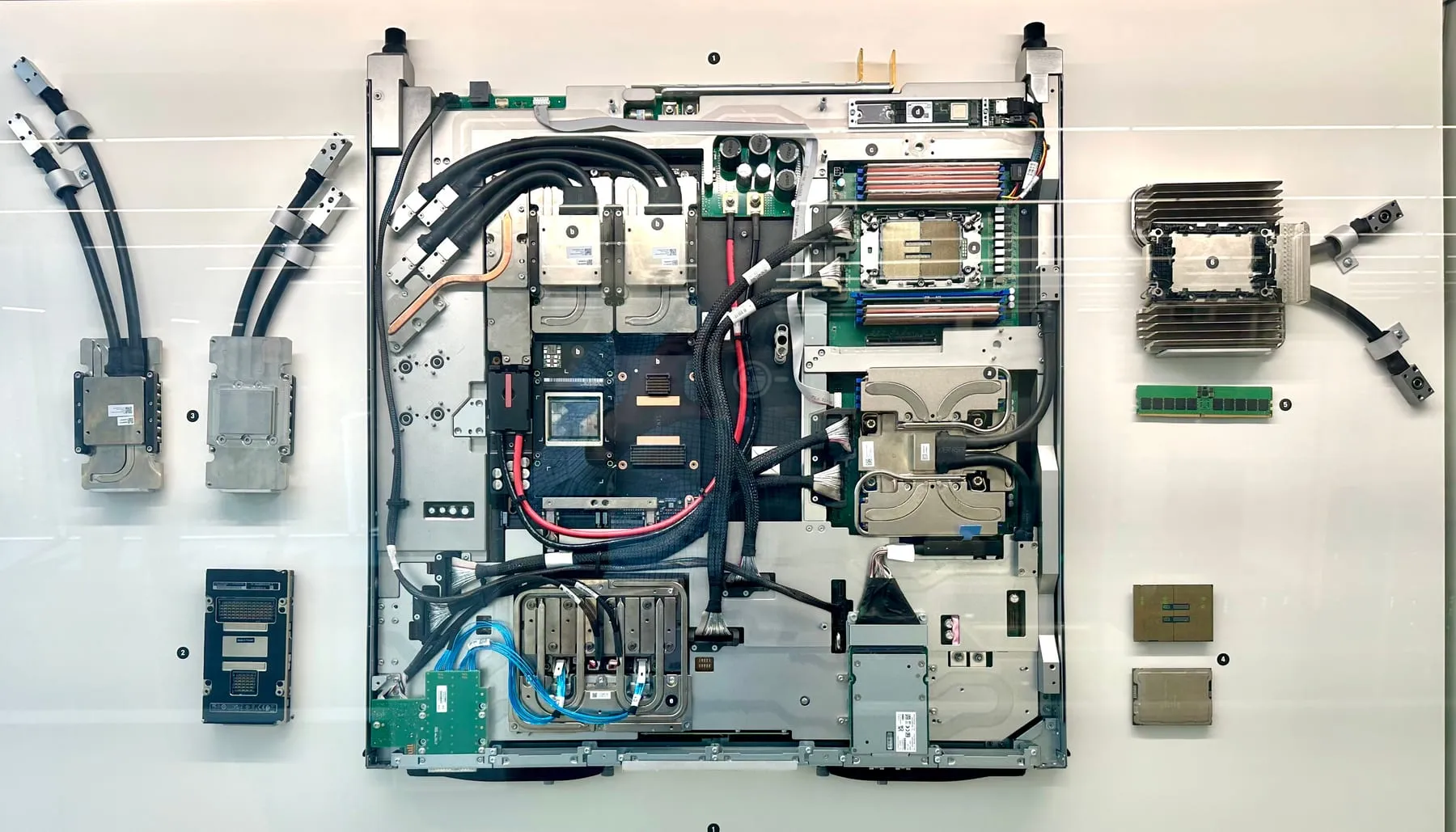 A dense blade of graphics processors wrapped in glycol cooling tubes, the hardware that runs large AI models in a data center.